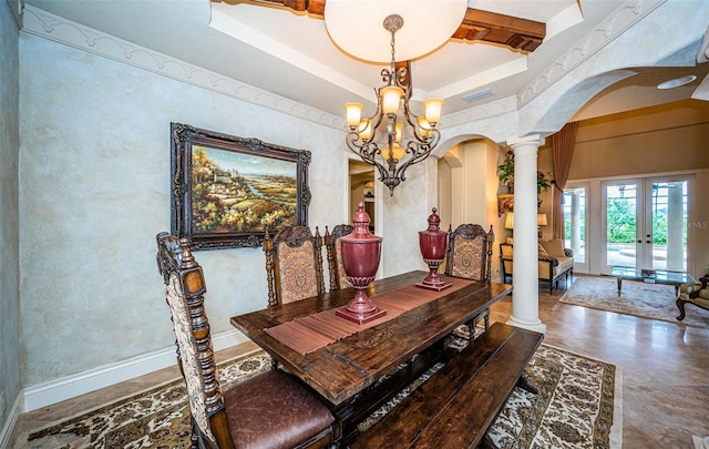 9943 Milano Dr, Trinity, FL 34655 - dining area with arched walkways, ornate columns, an inviting chandelier, and a raised ceiling