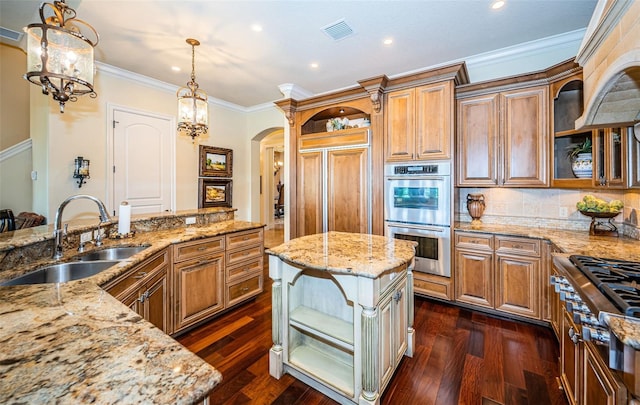 kitchen featuring a center island, stainless steel appliances, a chandelier, sink, and dark hardwood / wood-style floors