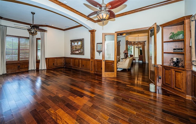 9943 Milano Dr, Trinity, FL 34655 - unfurnished room featuring wood finished floors, crown molding, arched walkways, ceiling fan, and wainscoting