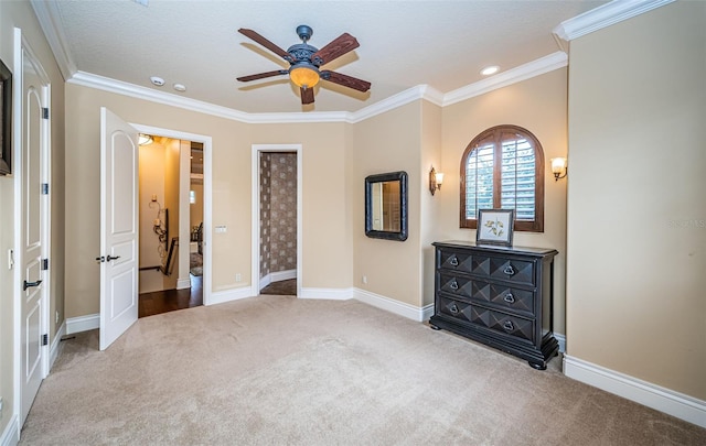 unfurnished bedroom with a textured ceiling, light colored carpet, ceiling fan, and ornamental molding