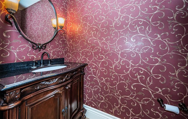9943 Milano Dr, Trinity, FL 34655 - bathroom featuring wallpapered walls and vanity