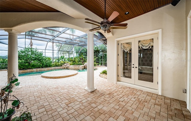 view of patio / terrace with french doors, glass enclosure, and ceiling fan