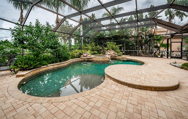 9943 Milano Dr, Trinity, FL 34655 - view of swimming pool with glass enclosure, a pool with connected hot tub, and a patio area