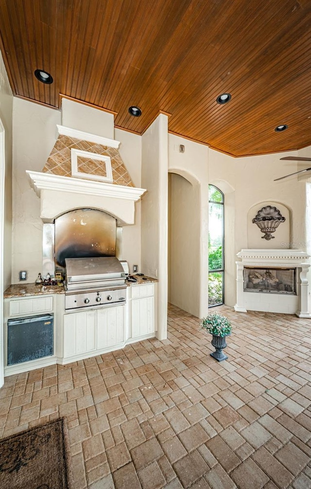 interior space with a grill, ceiling fan, and area for grilling