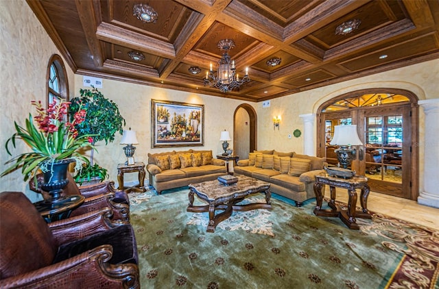 living room featuring coffered ceiling, beamed ceiling, decorative columns, crown molding, and a chandelier