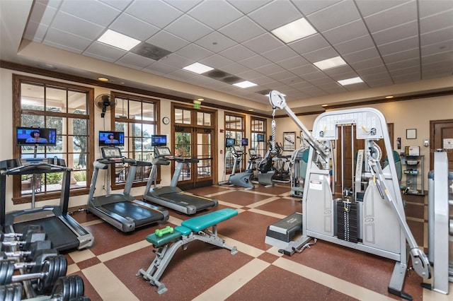 workout area with a paneled ceiling and french doors