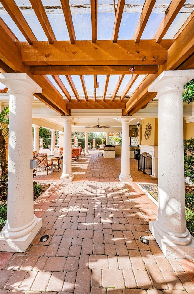 view of patio / terrace featuring ceiling fan and a pergola