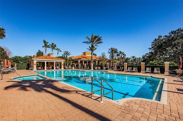 9943 Milano Dr, Trinity, FL 34655 - community pool featuring fence, an outdoor structure, a patio, and a hot tub