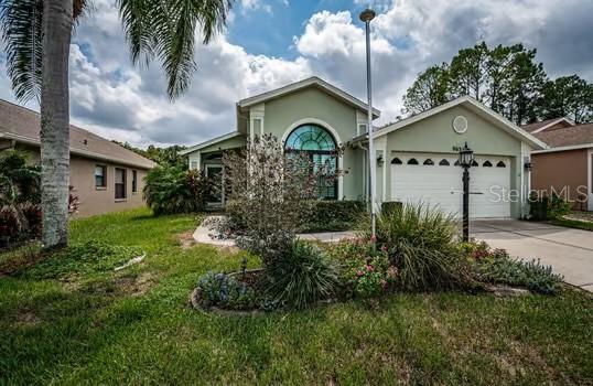 view of front of house with a garage and a front yard