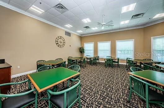 recreation room with ornamental molding, carpet flooring, a drop ceiling, and ceiling fan