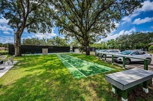 view of property's community with a lawn