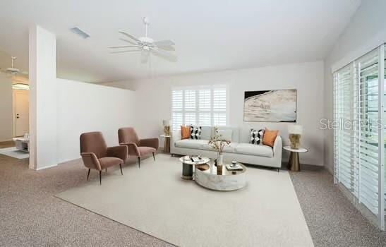 carpeted living room with plenty of natural light and ceiling fan