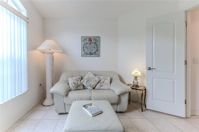 living room with a wealth of natural light and light tile patterned flooring