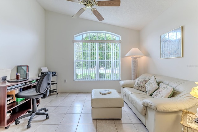 tiled office featuring ceiling fan, a textured ceiling, and vaulted ceiling