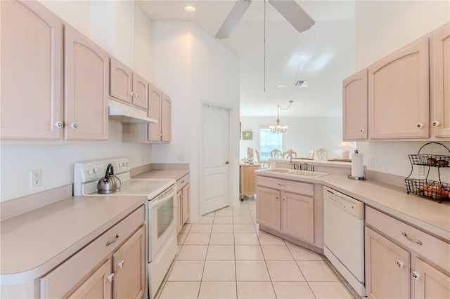 kitchen featuring ceiling fan with notable chandelier, white appliances, decorative light fixtures, and light brown cabinetry