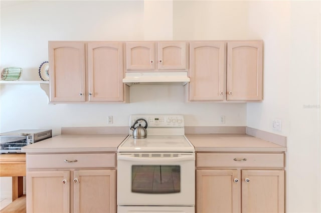 kitchen featuring electric stove and light brown cabinets