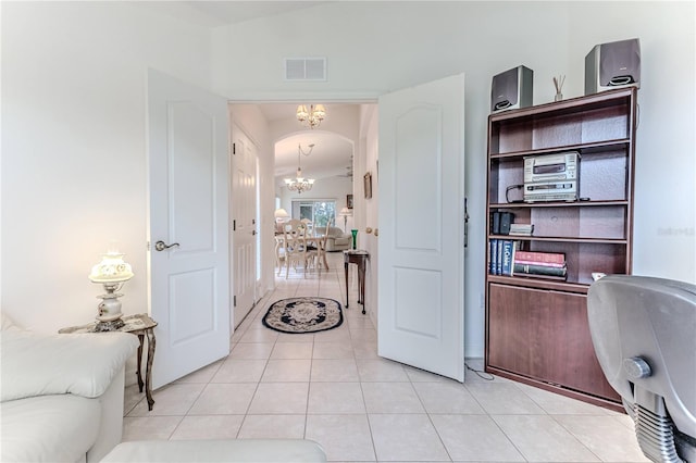 interior space featuring light tile patterned flooring and a notable chandelier