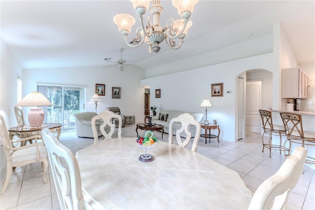 tiled dining area with lofted ceiling and ceiling fan with notable chandelier