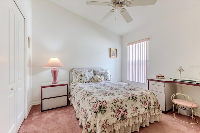 bedroom featuring light carpet, lofted ceiling, ceiling fan, and a closet