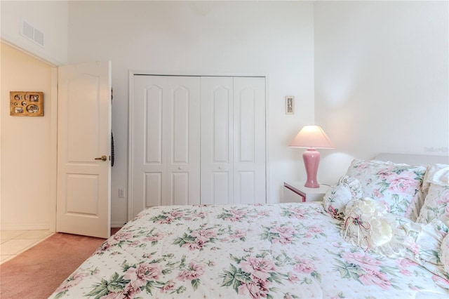 bedroom with a closet and light carpet