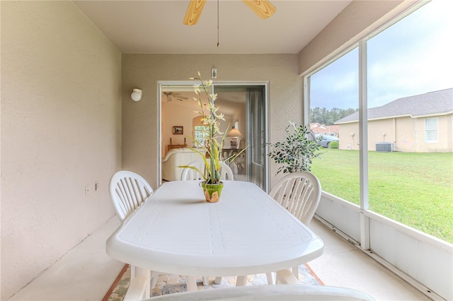 sunroom / solarium featuring ceiling fan and plenty of natural light