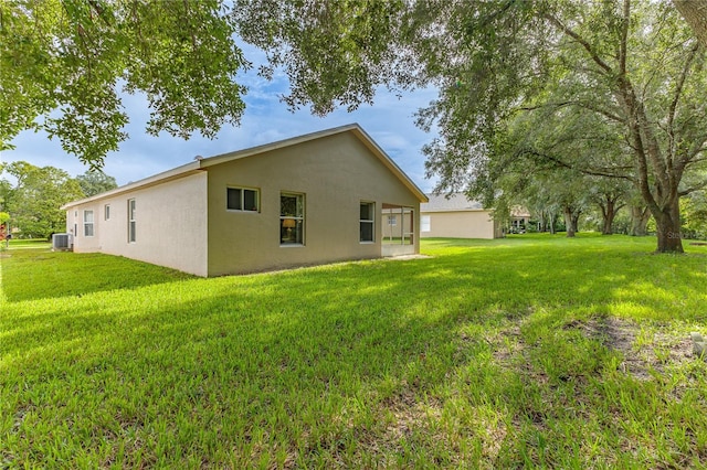 exterior space featuring central AC and a yard