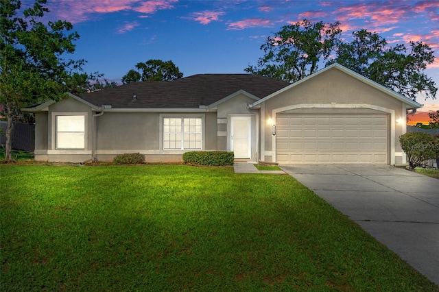 single story home featuring a yard and a garage