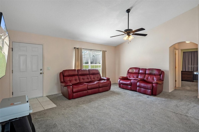 living room with ceiling fan, a textured ceiling, lofted ceiling, and light carpet