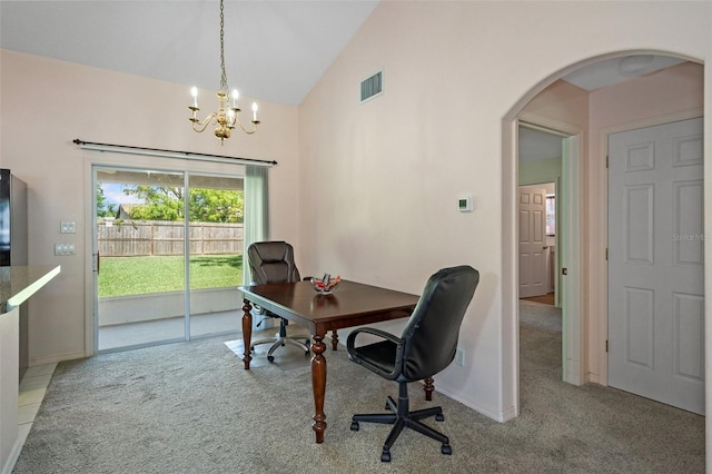 carpeted home office with an inviting chandelier and lofted ceiling