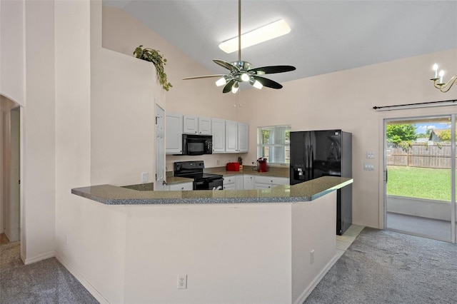 kitchen featuring black appliances, light colored carpet, white cabinets, a ceiling fan, and vaulted ceiling