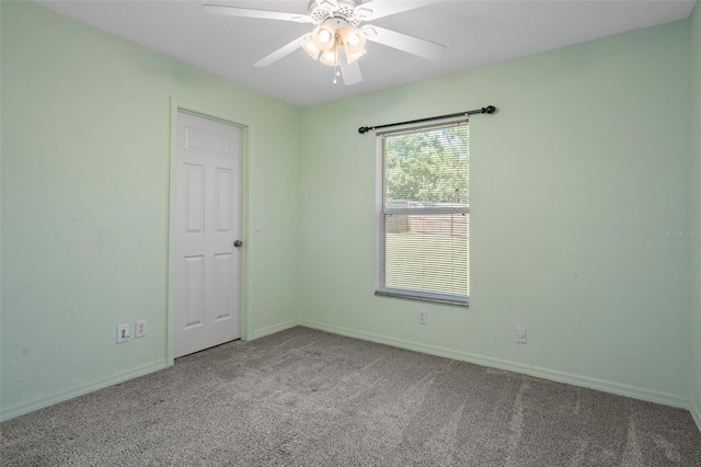 carpeted spare room featuring ceiling fan