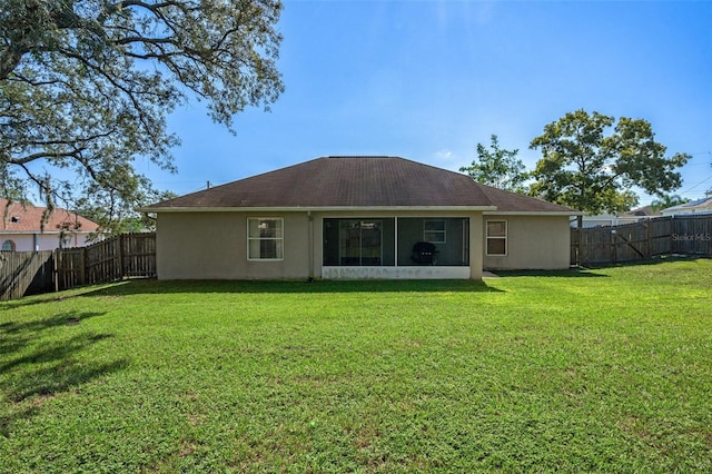 back of house featuring a yard