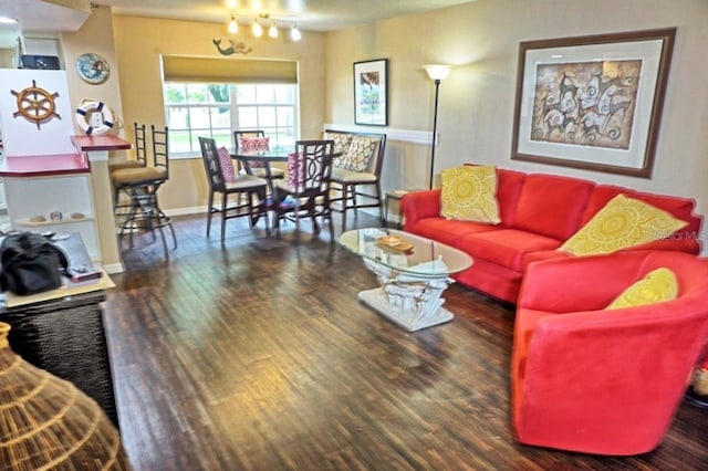 living room featuring wood finished floors and baseboards