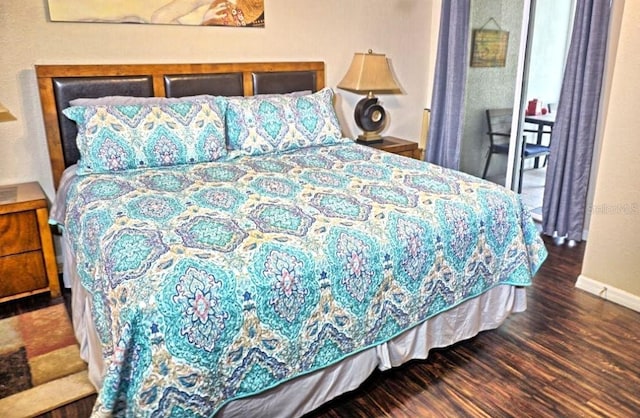 bedroom featuring wood finished floors and baseboards