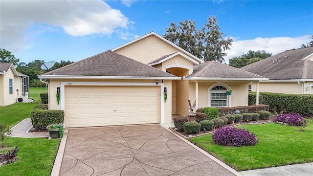 view of front of property with a front yard and a garage