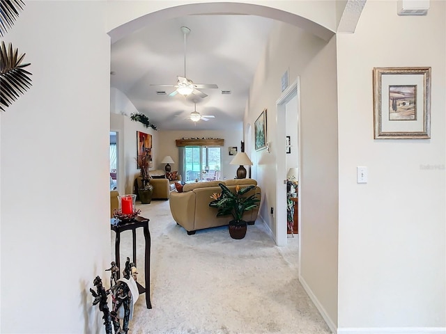 carpeted living room with lofted ceiling and ceiling fan