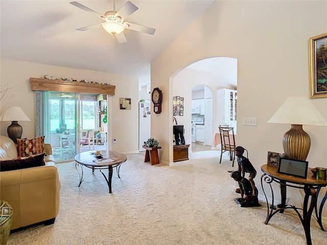 carpeted living room featuring ceiling fan and vaulted ceiling