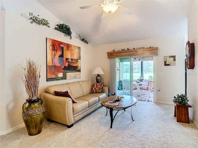 living room featuring ceiling fan, carpet floors, and vaulted ceiling