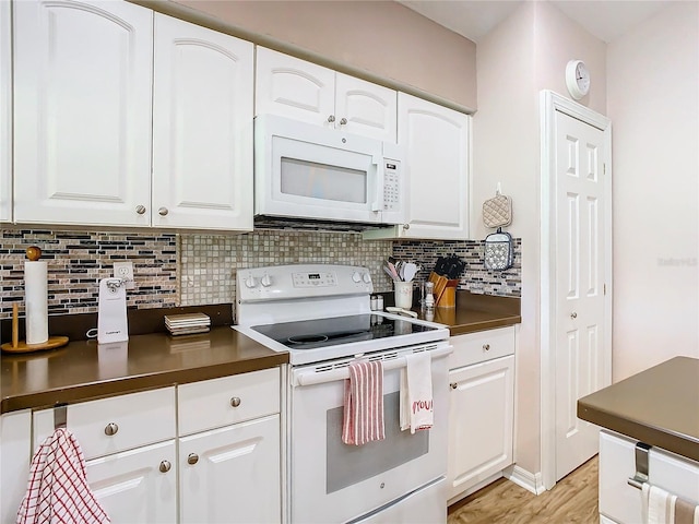 kitchen with white appliances, backsplash, white cabinets, and light hardwood / wood-style floors