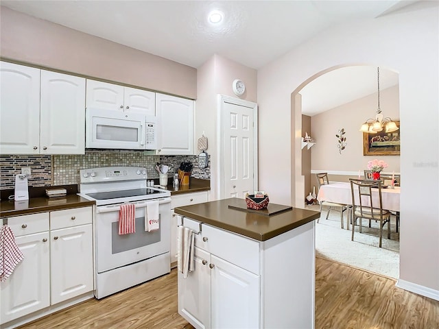 kitchen with white appliances and white cabinets