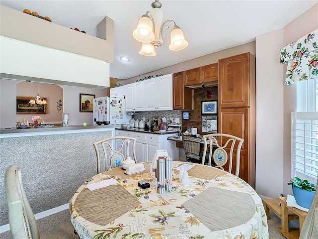 dining space featuring plenty of natural light and a notable chandelier