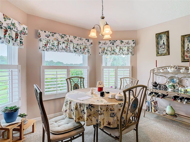 carpeted dining area with a wealth of natural light and a chandelier