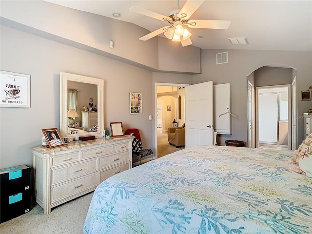 carpeted bedroom with vaulted ceiling, ensuite bathroom, and ceiling fan