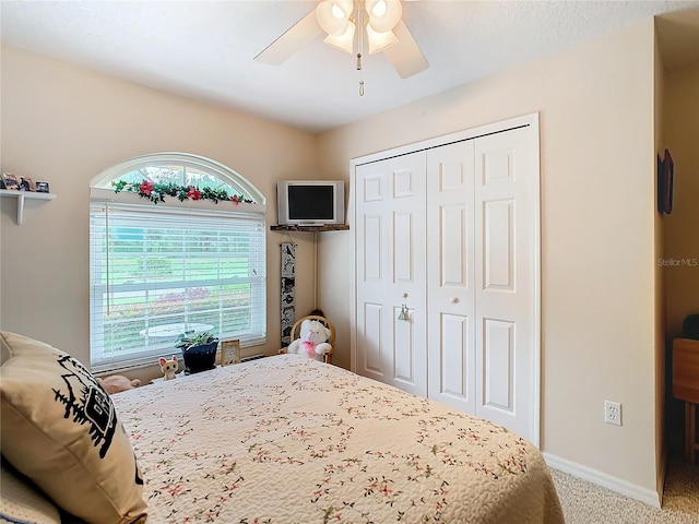 bedroom with ceiling fan, a closet, and carpet floors