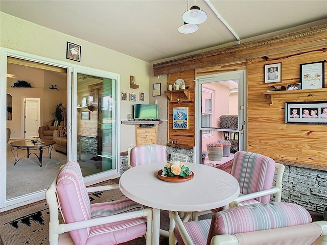 dining room with wooden walls