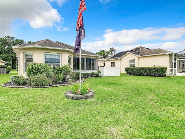 rear view of property with a lawn