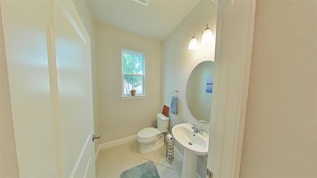 bathroom featuring vaulted ceiling, tile patterned flooring, and toilet