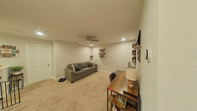 living room featuring ceiling fan and light colored carpet