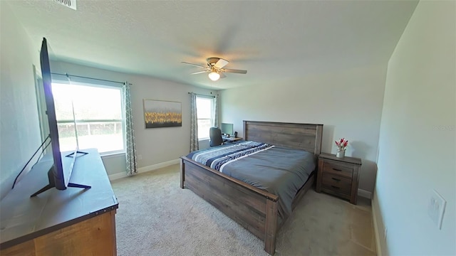 carpeted bedroom with a textured ceiling and ceiling fan