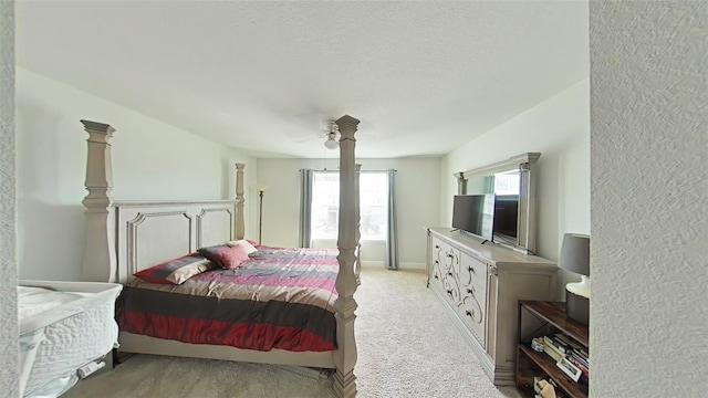 carpeted bedroom featuring a textured ceiling and ceiling fan